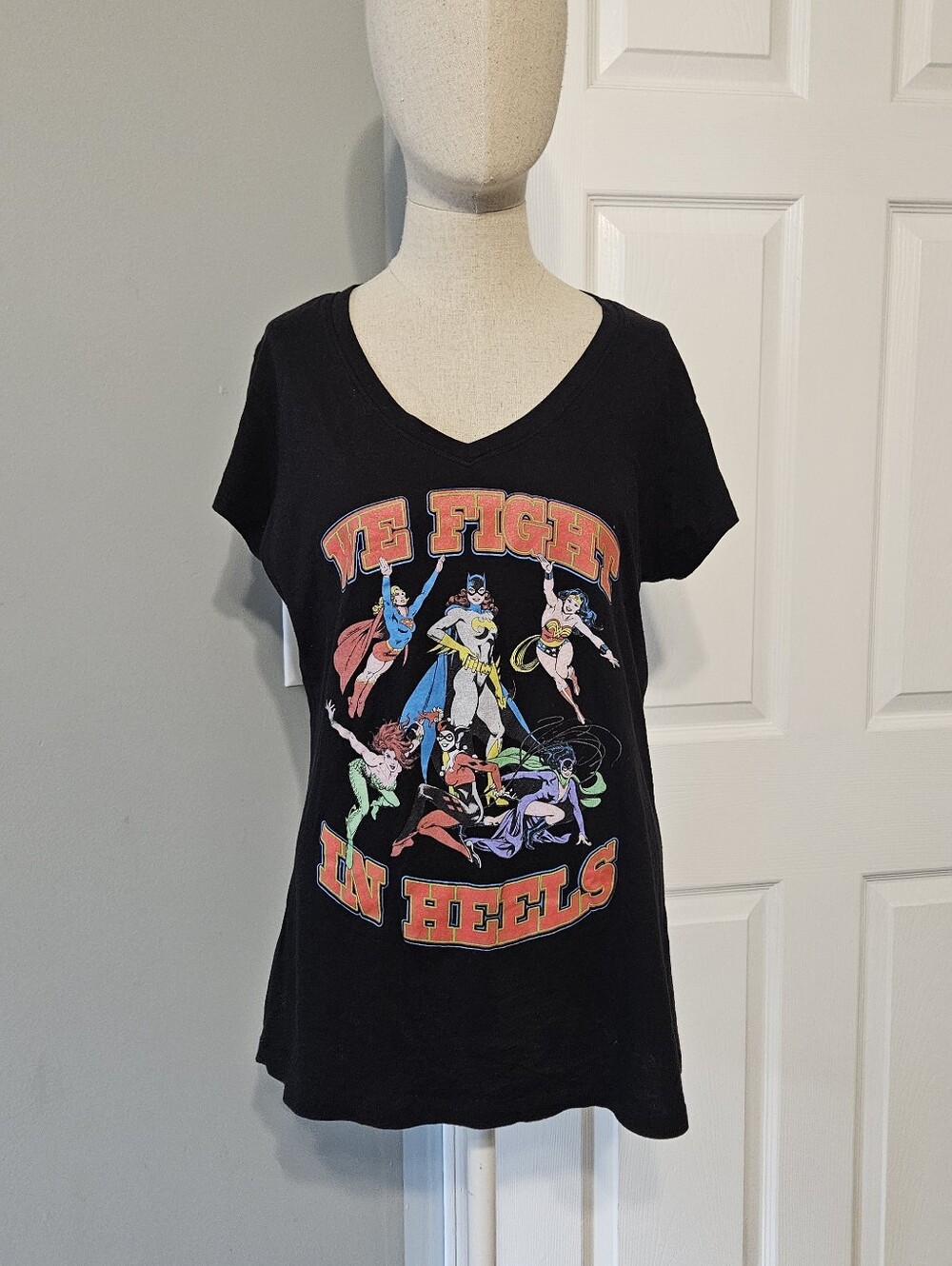 DC Black V-Neck Graphic Tee with Multi-Color 'We Fight in Heels' Print